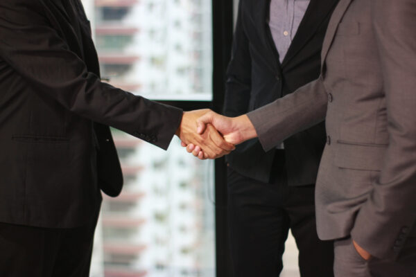 Businessmen making handshake in office business building